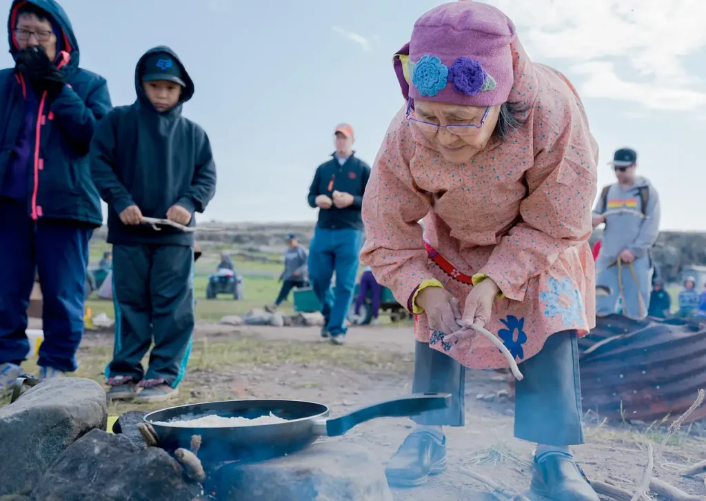 an Elder cooking over an open fire