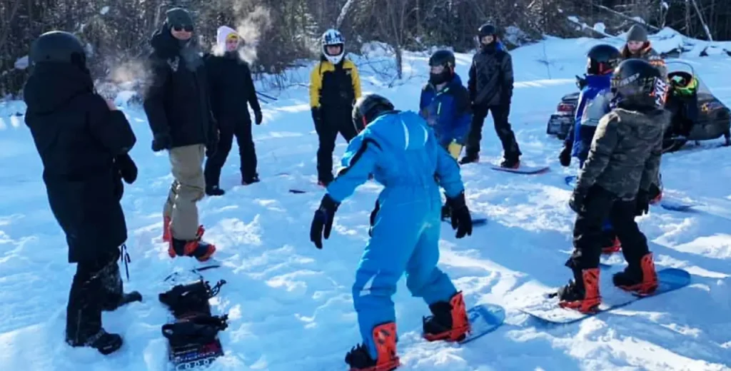 kids in the winter learning how to snowboard