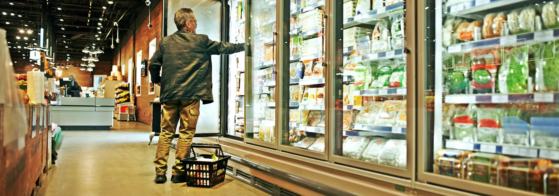 man reaching into freezer and picking some great frozen food