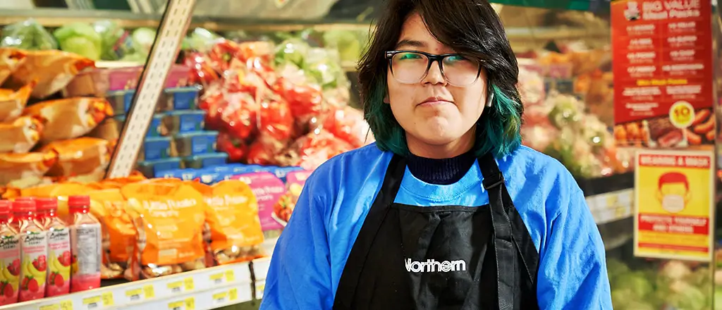 female Northern employee standing in front of packaged produce