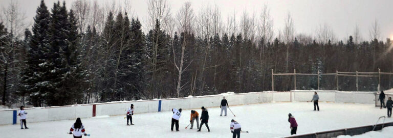 skaters playing hockey on outdoor ice rink
