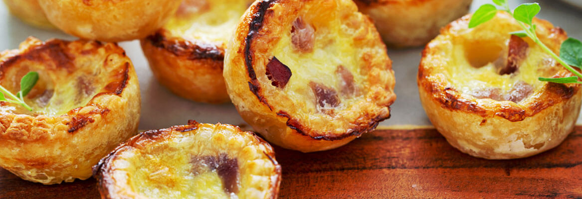 egg bites with bacon on a white plate