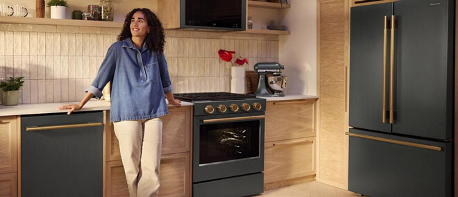 young woman leaning on counter with kitchen appliances