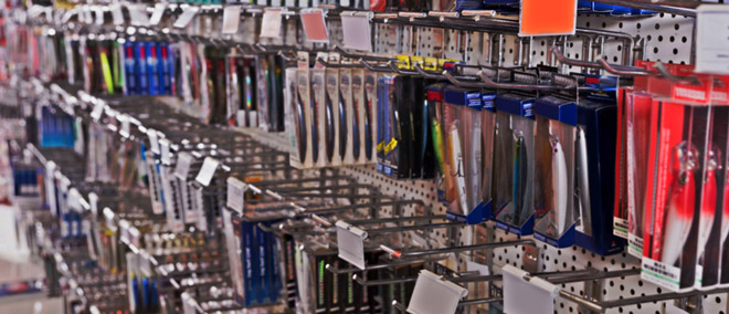 various fishing lures hanging on store board