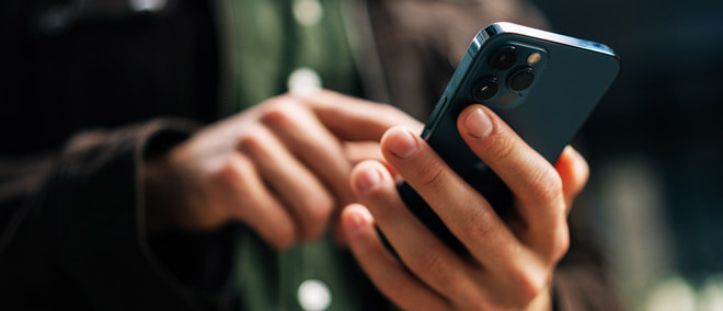 hand holding a cell phone calling with questions
