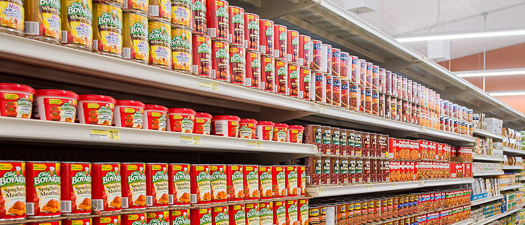 rows of canned pasta on shopping shelfs