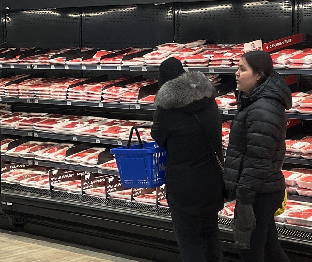 Two shoppers browsing the Fresh Meat section